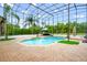 Enclosed pool area with palm trees, a seating area, and an arched structure at 2357 Alaqua Dr, Longwood, FL 32779