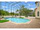 Large outdoor pool with screened enclosure, patio and lush landscaping in the backyard at 2357 Alaqua Dr, Longwood, FL 32779