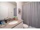 Bright bathroom featuring a shower with gray curtain and gray countertops at 3004 Protagonist St, Kissimmee, FL 34746