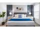 Comfortable bedroom featuring a stylish headboard, decorative wall art, and two nightstands at 3004 Protagonist St, Kissimmee, FL 34746