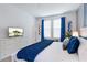 Bedroom featuring a comfortable bed, bedside tables with lamps and an entertainment center at 3004 Protagonist St, Kissimmee, FL 34746