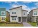 Modern two-story home with a combination of stucco, stone, and brick exterior and landscaped front yard at 3004 Protagonist St, Kissimmee, FL 34746
