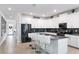 Modern kitchen with stainless steel appliances, gray backsplash and white cabinetry at 3004 Protagonist St, Kissimmee, FL 34746