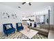 Bright and airy living room with blue accents, a marble coffee table, and open concept floor plan at 3004 Protagonist St, Kissimmee, FL 34746