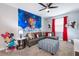 The living room features a gray couch, Mickey Mouse decor, and a striped ottoman at 3004 Protagonist St, Kissimmee, FL 34746
