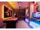 A fun game room with air hockey table, arcade games, and a TV with neon lights at 3004 Protagonist St, Kissimmee, FL 34746