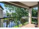 View from the balcony overlooking lush foliage and a waterway, great for relaxing outdoors at 3028 Parkway Blvd # 308, Kissimmee, FL 34747