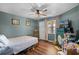 Cozy bedroom featuring hardwood floors, ceiling fan, and natural light at 3028 Parkway Blvd # 308, Kissimmee, FL 34747