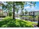 Picturesque community pond surrounded by lush greenery and residential buildings, creating a serene environment at 3028 Parkway Blvd # 308, Kissimmee, FL 34747