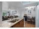 A contemporary kitchen with granite counters, wood cabinets, and an open view to the living and dining areas at 3028 Parkway Blvd # 308, Kissimmee, FL 34747
