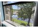 Scenic lake view from a window with pool and lush surroundings at 3028 Parkway Blvd # 308, Kissimmee, FL 34747