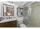 Bathroom with sliding glass door shower, modern vanity, and decorative shelving at 310 E Gulley Ave, Oakland, FL 34760