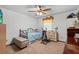 Cozy bedroom features ceiling fan, carpet, and a window that allows plenty of natural light at 310 E Gulley Ave, Oakland, FL 34760