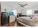 Comfortable bedroom features wood floors, ceiling fan, safe, and built-in desk at 310 E Gulley Ave, Oakland, FL 34760