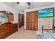 Bedroom with ceiling fan, tv, closet with louvered doors, and a dresser with mirror at 310 E Gulley Ave, Oakland, FL 34760