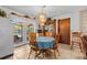 Bright dining room featuring access to a backyard pool, a view to the kitchen, and a traditional chandelier at 310 E Gulley Ave, Oakland, FL 34760