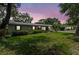 Charming single-story home featuring a well-maintained lawn and mature trees offering plenty of shade and curb appeal at 310 E Gulley Ave, Oakland, FL 34760