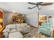 Spacious living room featuring wood-look flooring, comfortable seating, built in shelving, and an open view to the kitchen at 310 E Gulley Ave, Oakland, FL 34760