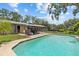 A beautiful in-ground pool, a gazebo, and a well-manicured lawn grace the backyard of this charming home at 310 E Gulley Ave, Oakland, FL 34760