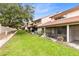 Townhome backyard with green grass and mature trees at 3336 Gray Fox Cv # 3336, Apopka, FL 32703