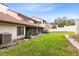 Townhome backyard with green grass and an AC Unit at 3336 Gray Fox Cv # 3336, Apopka, FL 32703