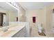 Bathroom featuring dual sinks, a tub, and a toilet with wood-look tile flooring at 3336 Gray Fox Cv # 3336, Apopka, FL 32703
