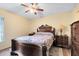 Bedroom featuring a wooden bedframe, ceiling fan, and two nightstands at 3336 Gray Fox Cv # 3336, Apopka, FL 32703