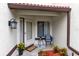 Welcoming front porch area with a chair, small table, potted plants, and a 'Welcome' mat at 3336 Gray Fox Cv # 3336, Apopka, FL 32703