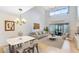 Bright living area features vaulted ceilings, dining area, and sliding glass doors to the lanai at 3336 Gray Fox Cv # 3336, Apopka, FL 32703