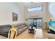 Spacious living room with large windows, sliding glass doors, hardwood flooring and comfortable seating at 3336 Gray Fox Cv # 3336, Apopka, FL 32703