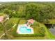 Aerial view of the community pool, with a pool house and many mature trees at 3336 Gray Fox Cv # 3336, Apopka, FL 32703