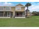 Home featuring a serene screened-in patio and a spacious, well-maintained backyard at 4178 Sw 43Rd Cir, Ocala, FL 34474