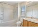 Bathroom with a tub and shower combo, tiled floor, single sink vanity, and a bright window at 4178 Sw 43Rd Cir, Ocala, FL 34474