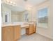 Bright bathroom featuring double sinks, an oversized mirror, and ample natural light from a window at 4178 Sw 43Rd Cir, Ocala, FL 34474