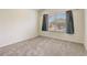 Bright bedroom featuring a window with blinds and curtains, light gray carpet, and neutral walls at 4178 Sw 43Rd Cir, Ocala, FL 34474