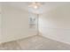A simple bedroom with a large window, ceiling fan, neutral carpet, and a picture rail at 4178 Sw 43Rd Cir, Ocala, FL 34474