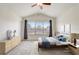 Bedroom with neutral walls and flooring, featuring a window, ceiling fan, and modern decor and furniture at 4178 Sw 43Rd Cir, Ocala, FL 34474