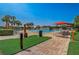 Community pool area featuring a pool, lounge chairs, umbrellas, and palm trees at 4178 Sw 43Rd Cir, Ocala, FL 34474