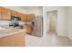 Well-equipped kitchen with stainless steel appliances, and light tile flooring at 4178 Sw 43Rd Cir, Ocala, FL 34474
