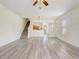 Bright living room with modern wood-look floors, stairs, and open layout to the kitchen at 4178 Sw 43Rd Cir, Ocala, FL 34474