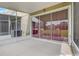 Screened patio with concrete floors and a view of the lawn and neighboring buildings at 4178 Sw 43Rd Cir, Ocala, FL 34474