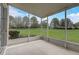 Comfortable screened porch offering views of lush greenery and blue skies at 4178 Sw 43Rd Cir, Ocala, FL 34474