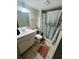 Cozy bathroom with single vanity, shower-tub combination with decorative curtain at 4364 White Pine Ave # 3, Orlando, FL 32811