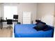 Comfortable bedroom featuring a blue-covered bed, workspace, and plenty of natural light at 4364 White Pine Ave # 3, Orlando, FL 32811