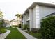 Exterior side view of a charming townhouse with a sidewalk and lush landscaping at 4364 White Pine Ave # 3, Orlando, FL 32811