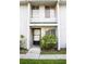 Charming townhome with a front entrance with flowering shrubs and a well maintained sidewalk at 4364 White Pine Ave # 3, Orlando, FL 32811