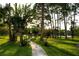 Scenic walkway through a lush green lawn with mature trees, creating a peaceful and inviting atmosphere at 4364 White Pine Ave # 3, Orlando, FL 32811