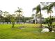 Community pool area with palm trees, a fenced perimeter, and a building, offering a relaxing space at 4364 White Pine Ave # 3, Orlando, FL 32811