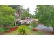 Aerial view of a home with a red tile roof, lush landscaping, an enclosed pool, and a circular driveway at 4420 Conway Gardens Rd, Orlando, FL 32806