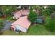 Bird's eye view of home showcasing its red-tiled roof, screened pool enclosure, lush backyard, and overall property layout at 4420 Conway Gardens Rd, Orlando, FL 32806